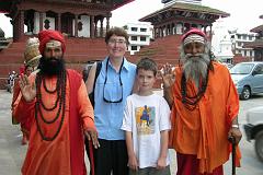 Kathmandu 02-2 Kathmandu Durbar Square Charlotte Ryan And Peter Ryan With two Hindu Sadhus Peter Ryan and Charlotte Ryan pose with two Hindu sadhus in Kathmandu's Durbar Square, with the Trailokya Mohan Narayan and Maju Deval Temples behind.